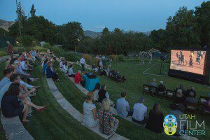 The garden party crowd looks on as "Rising From Ashes" begins to play.