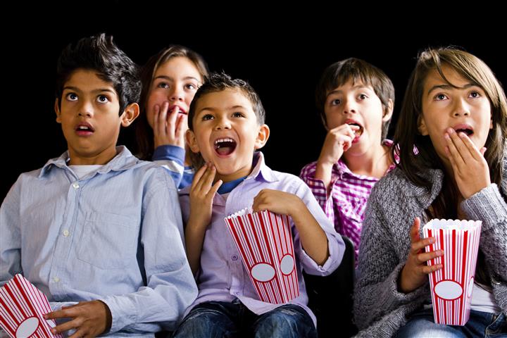 Group of kids watching a film at the movies